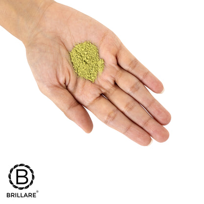 Coin size Brillare Neem powder face wash on palm, with Brillare logo.