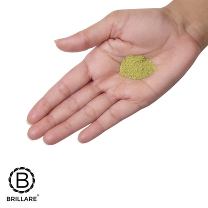 Coin size Brillare Neem powder face wash on palm, with Brillare logo.